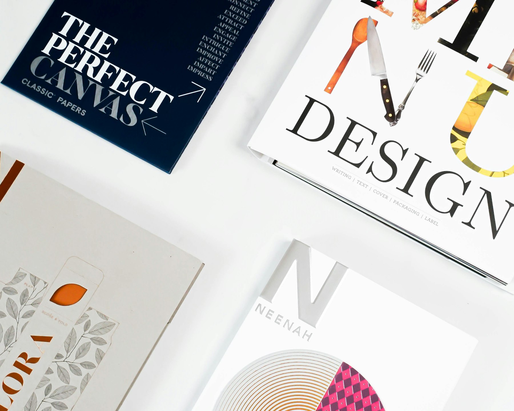 Printed magazine covers and brochures laid out on a table